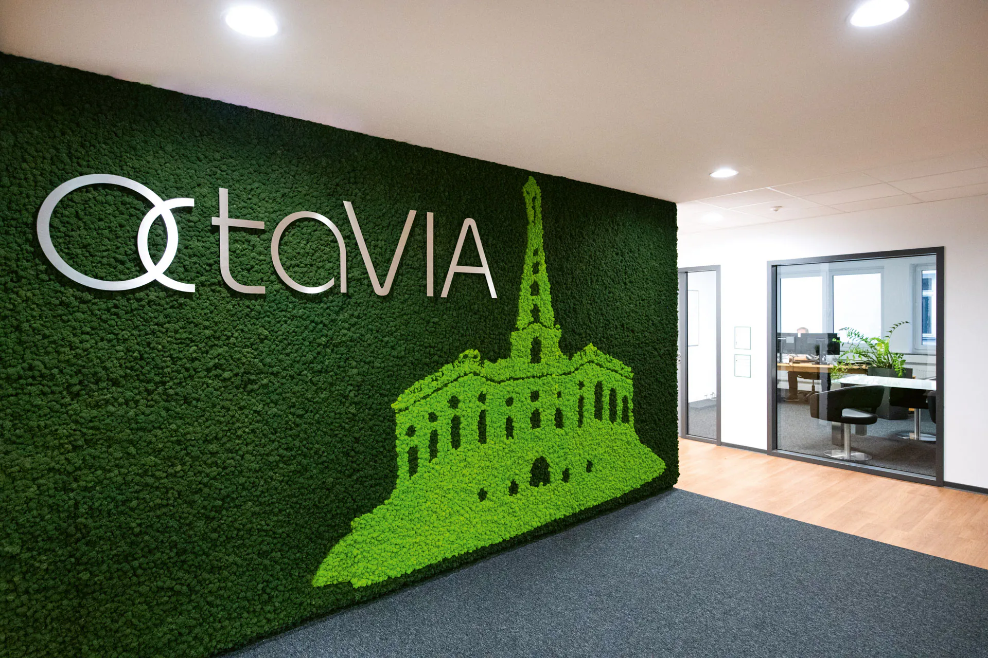 A Moss picture featuring a logo in a modern office reception area