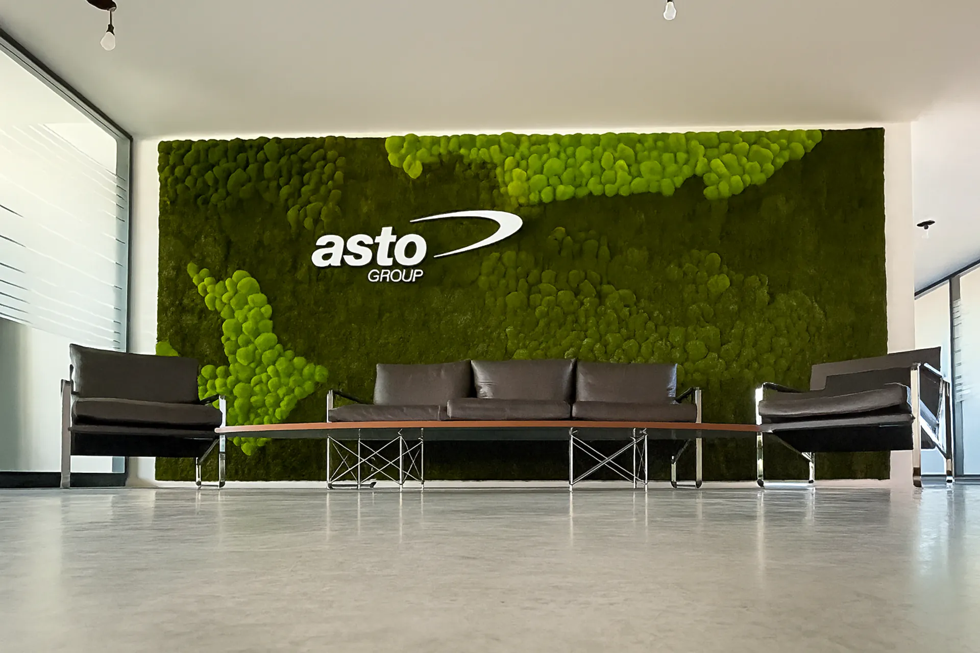Company logo made from preserved moss on a reception wall