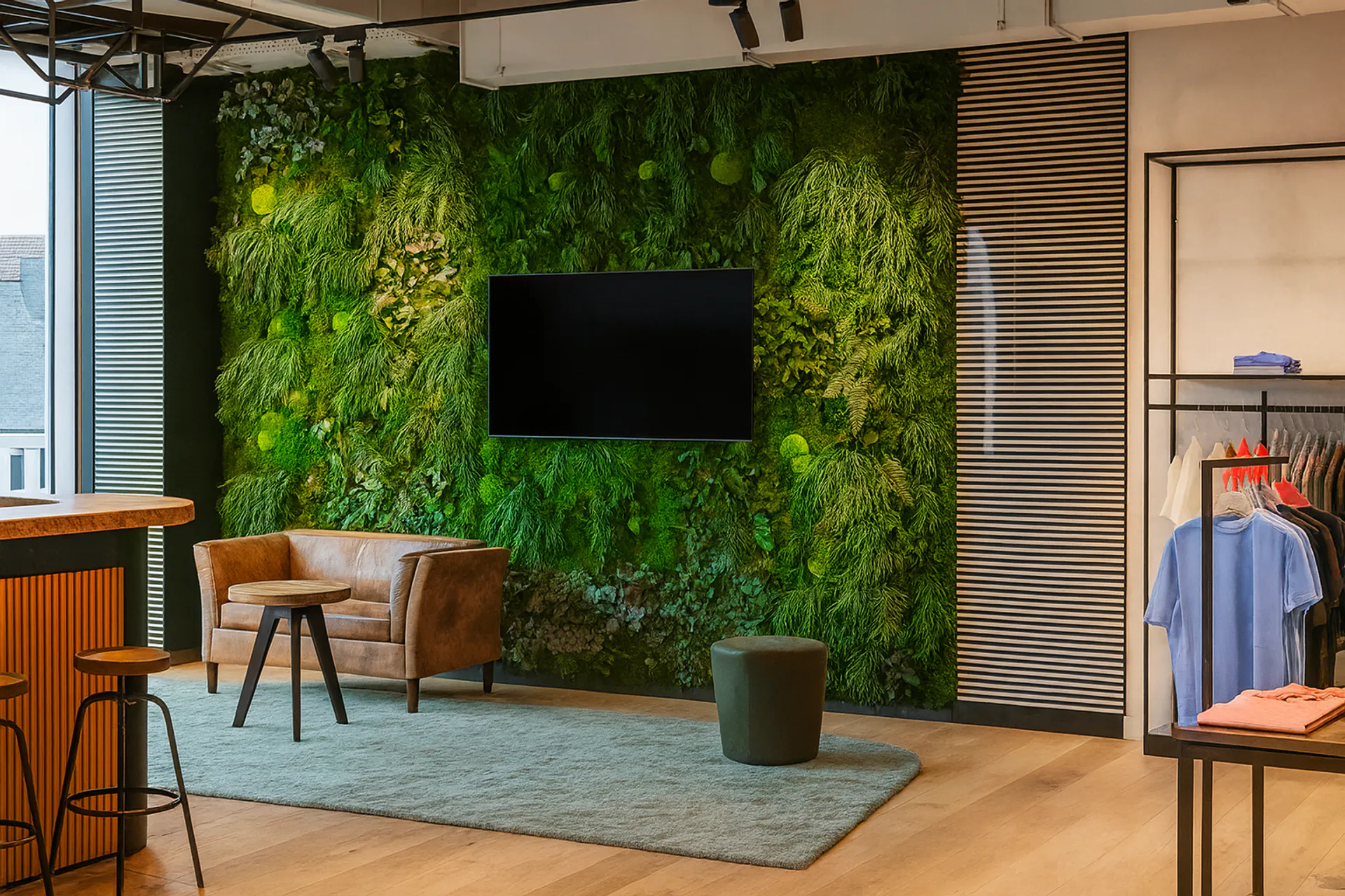 A moss wall by MOOSMOOS in a modern office reception area — reference for the tender