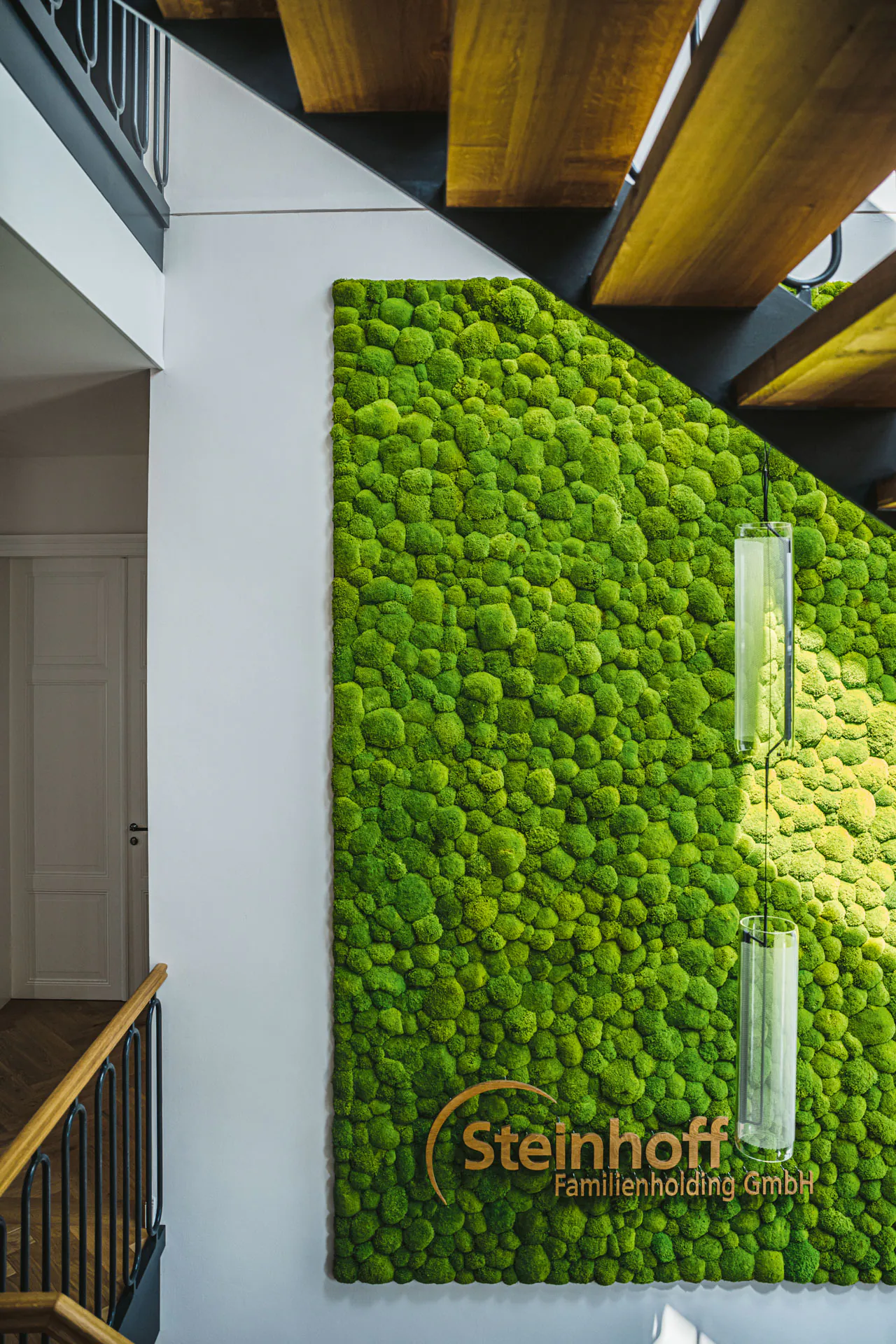 Moss wall in a modern lobby stairwell — Wall greenery by MOOSMOOS
