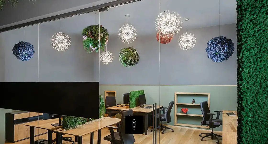 a room with a computer desk and chairs