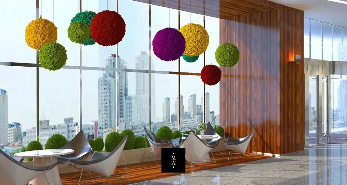 a room with chairs and tables and colorful balls from ceiling