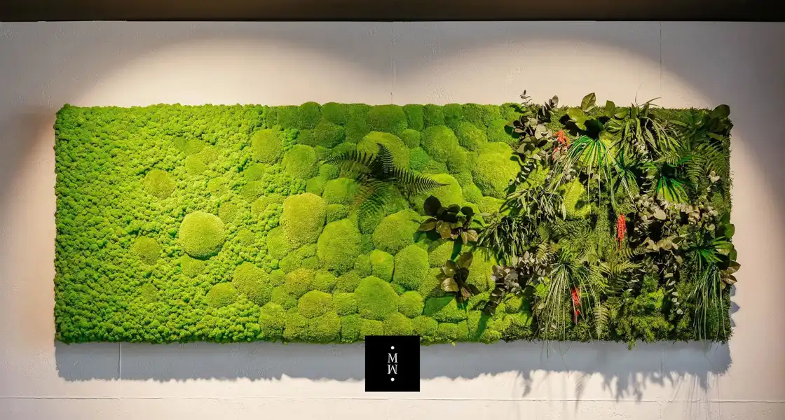 a green wall with plants and leaves