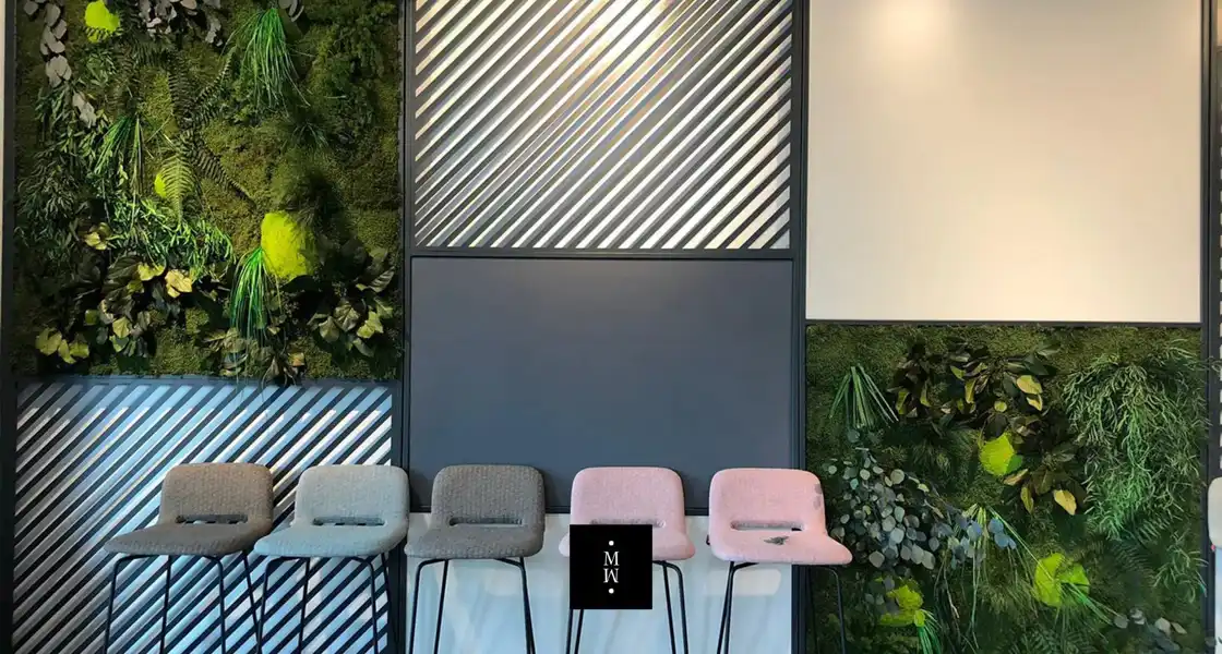 a row of chairs in front of a wall