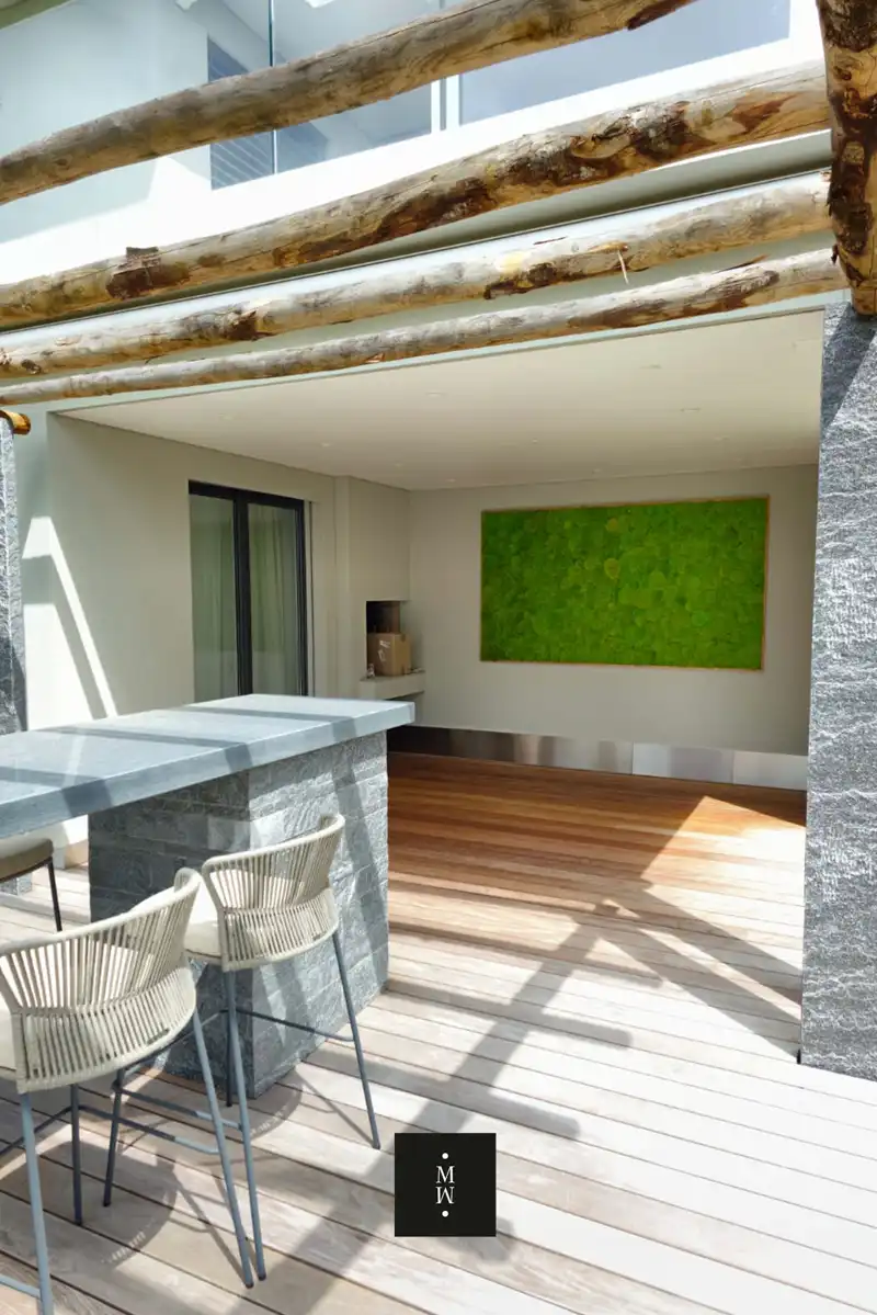 a patio with a bar and chairs