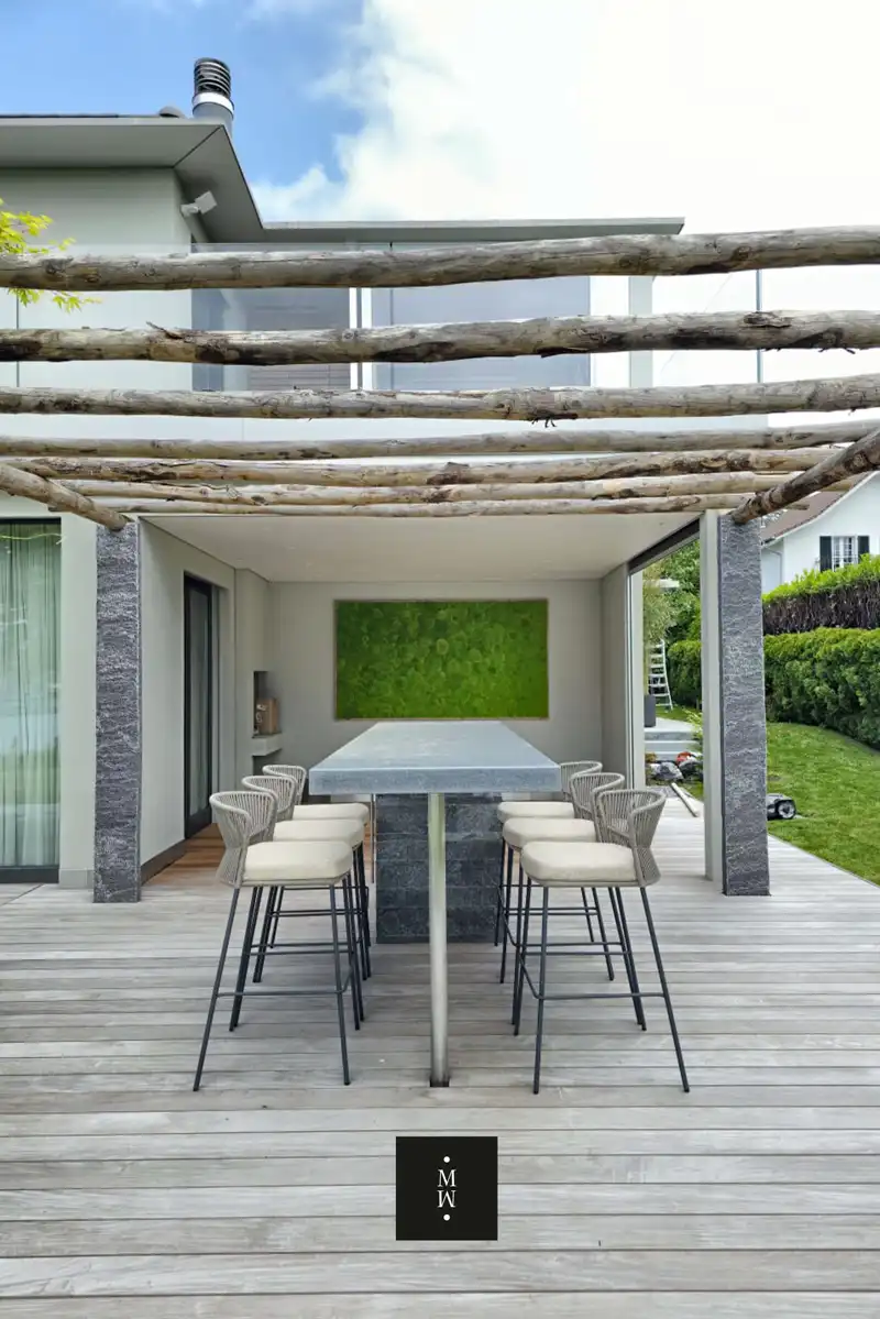 a table and chairs under a wooden pergola