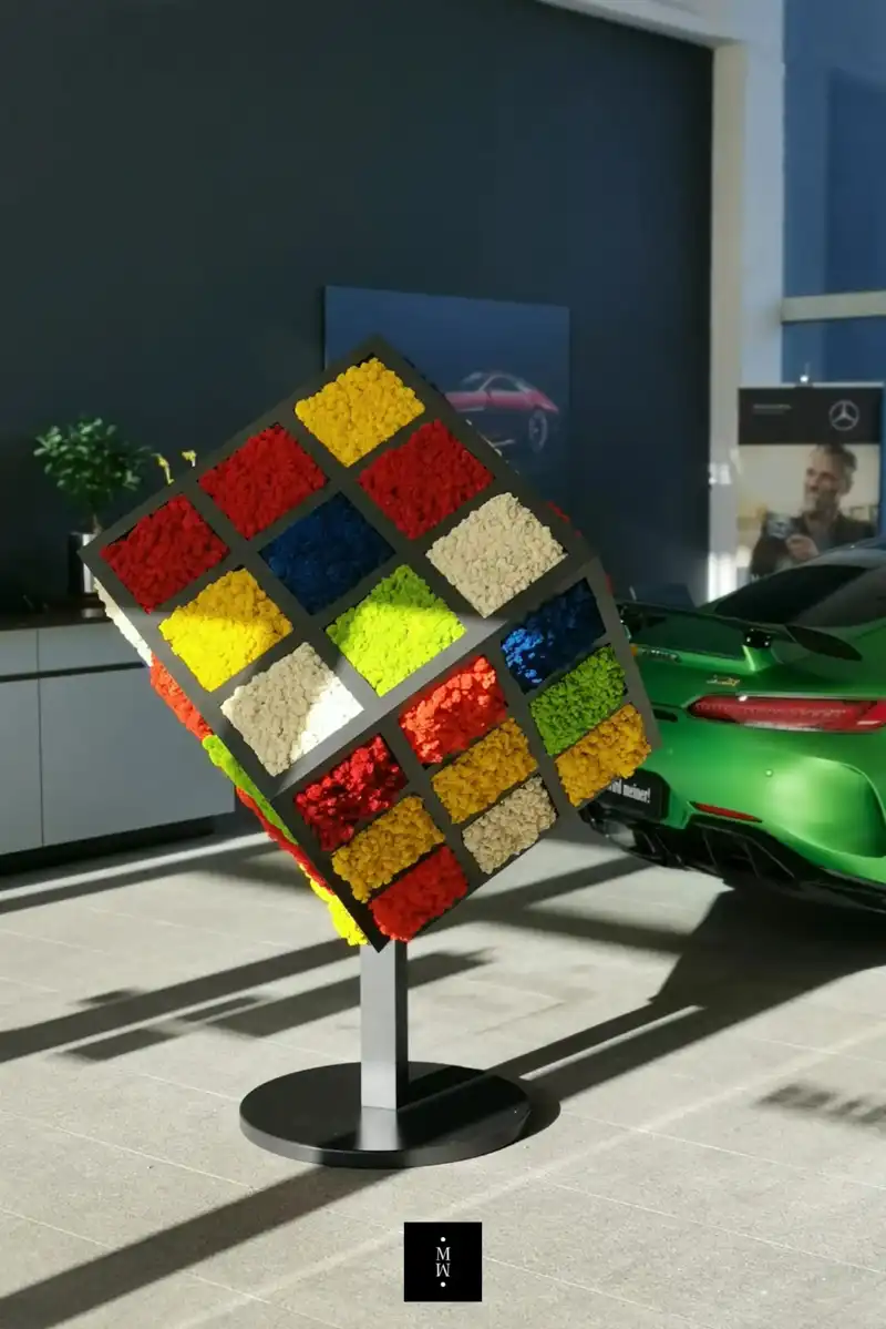 a colorful cube sculpture in a showroom