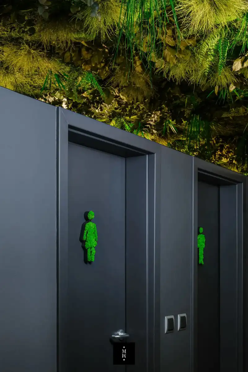 a group of doors with green figures on them