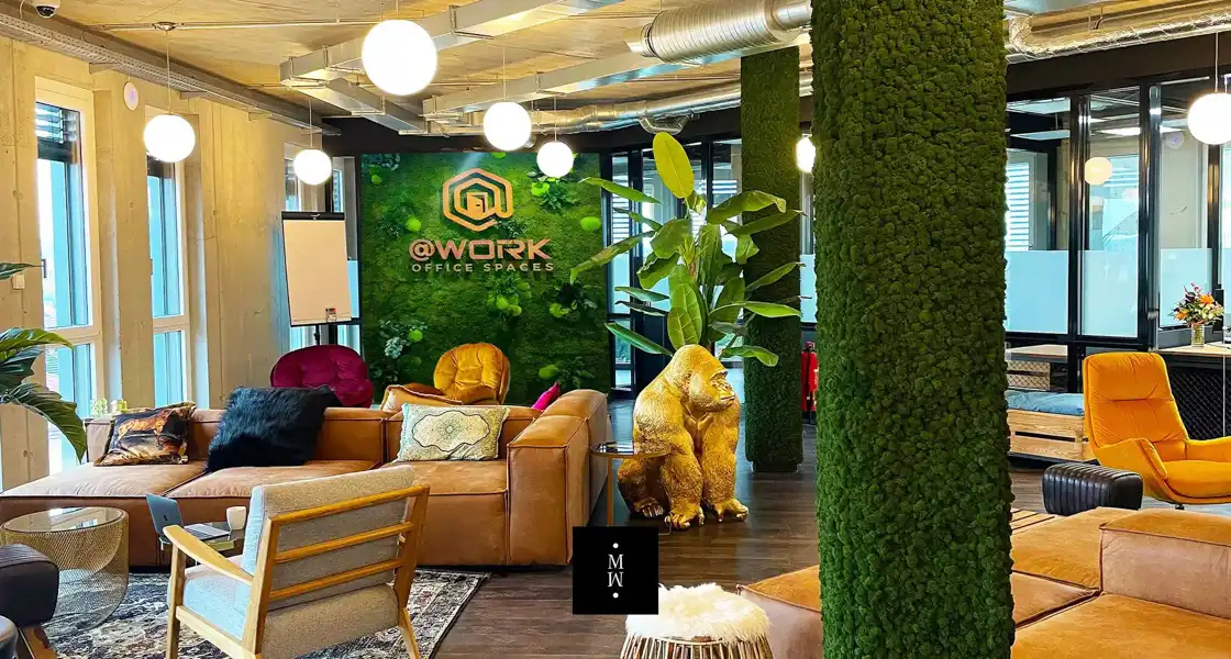 a room with a green wall and plants