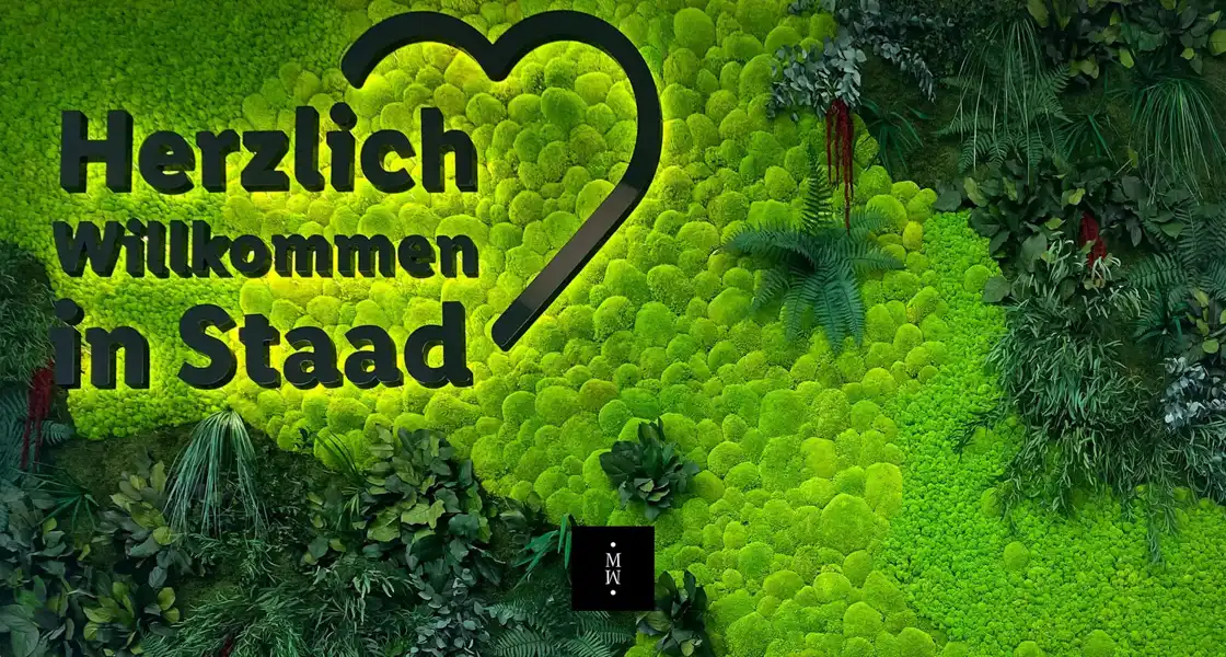 a green wall with plants and a heart