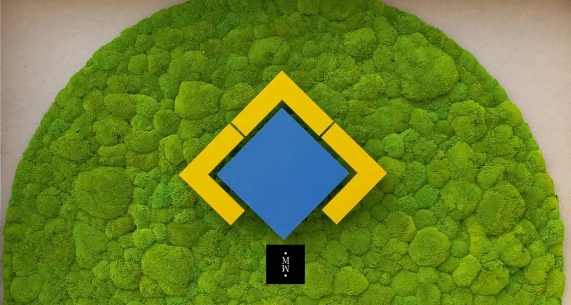 a blue and yellow square on a green wall