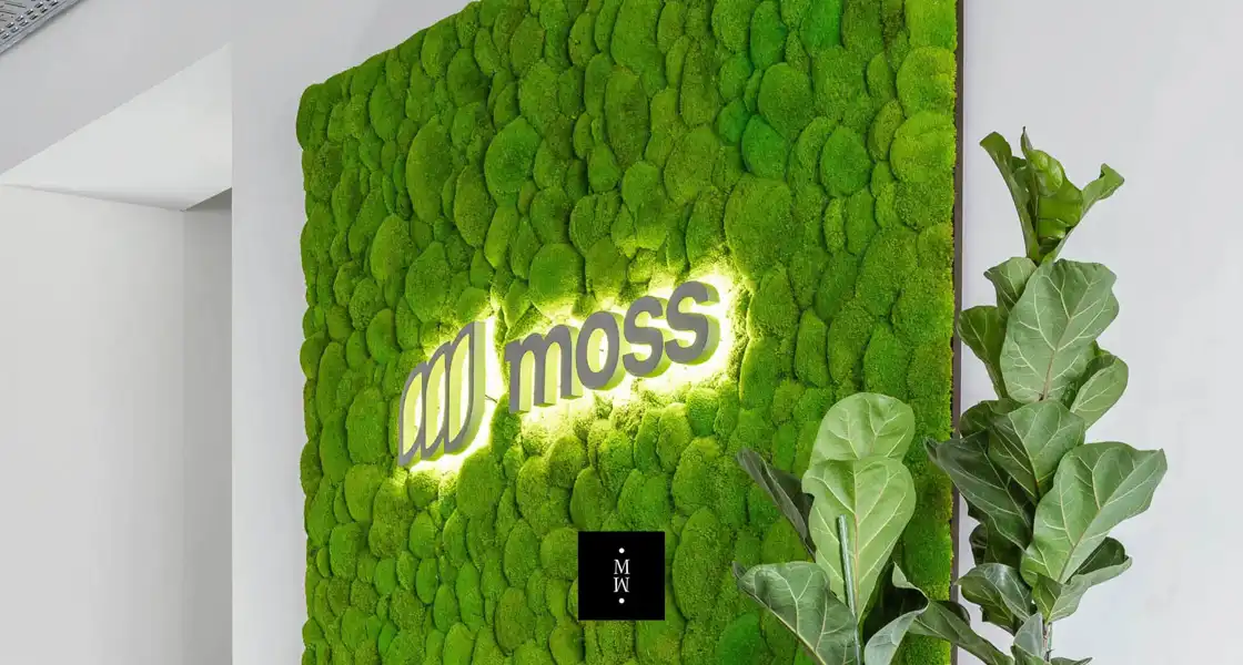 a green wall with a logo
