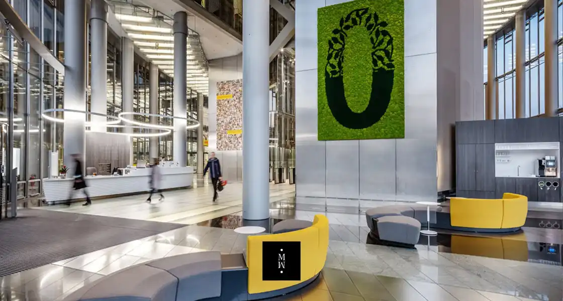 a lobby with a large green sign and a large number on the wall
