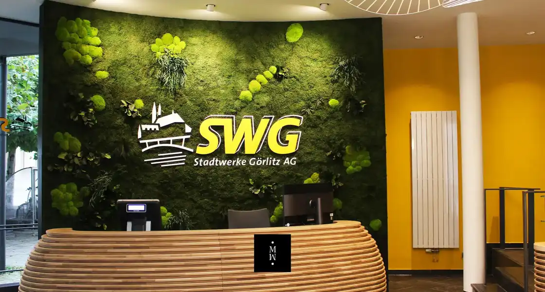 a green wall with a sign on it