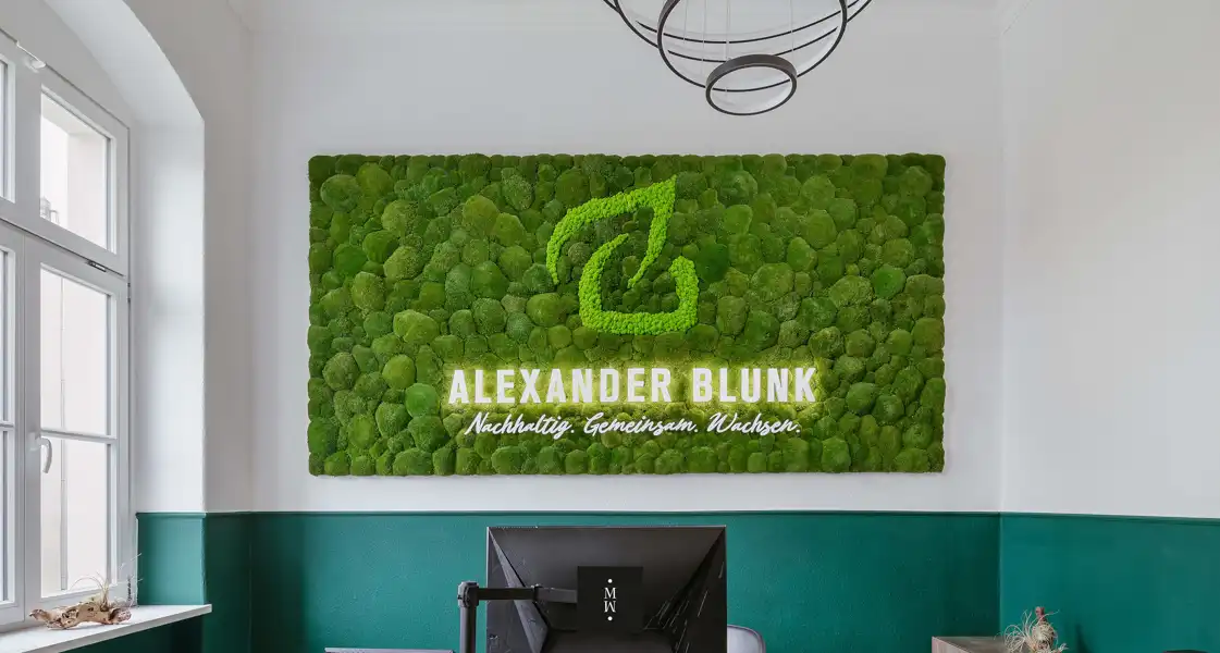 a green wall with a sign on it