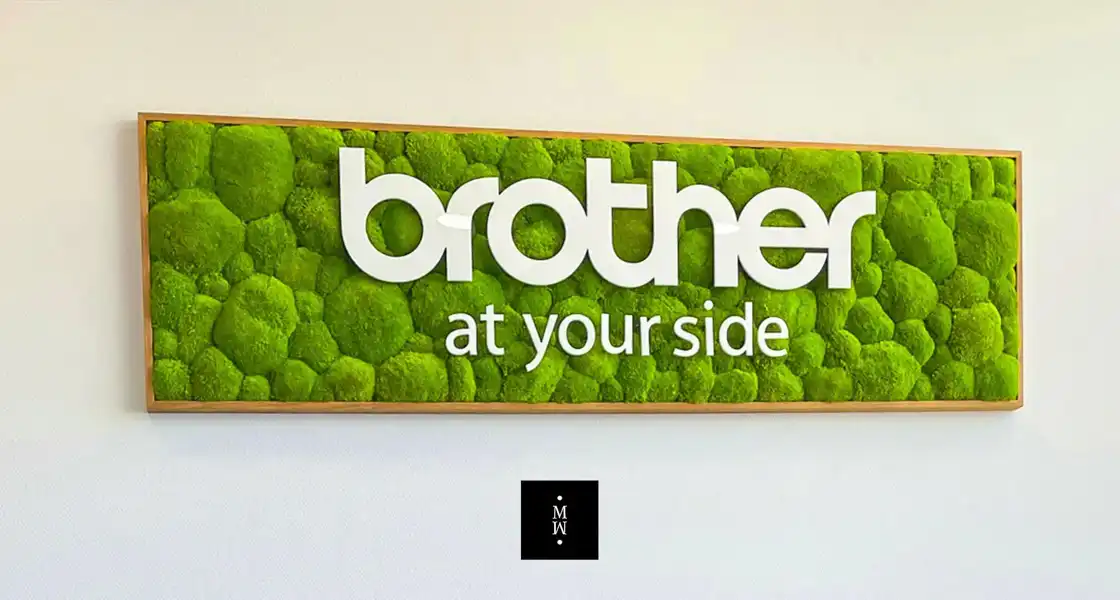 a sign with a green mossy surface