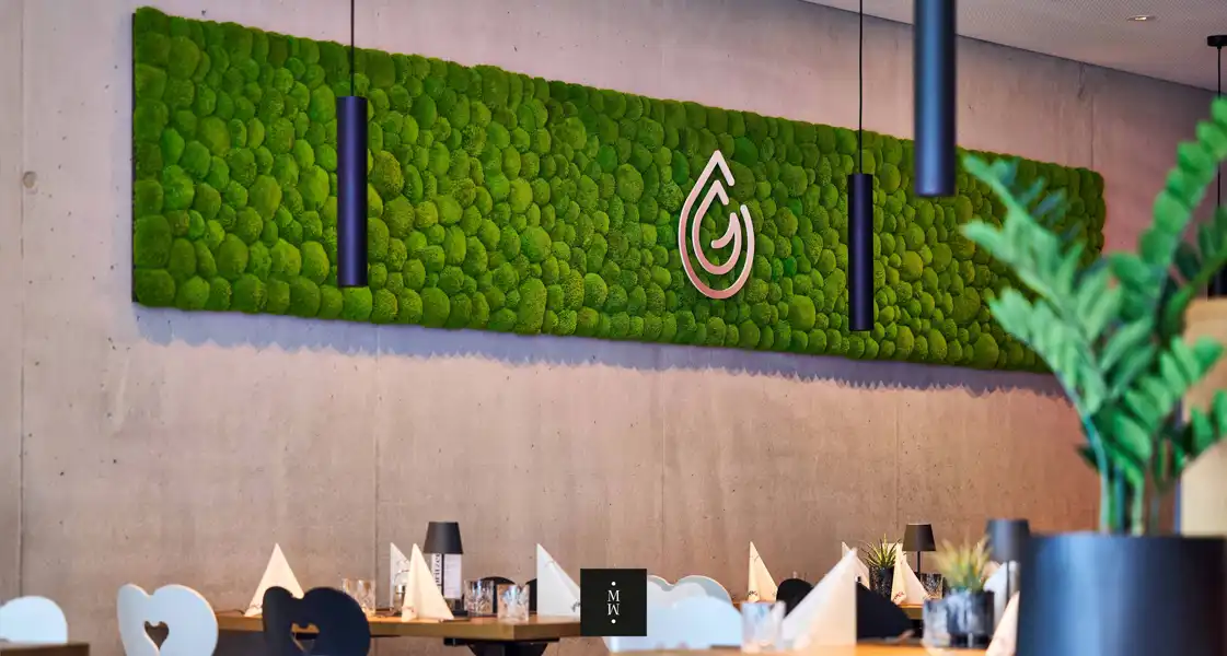 a restaurant with a green wall and a sign