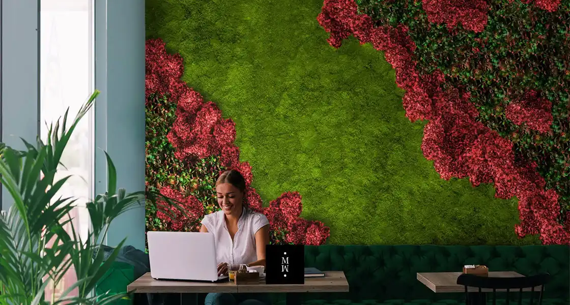 a woman sitting at a table with a laptop