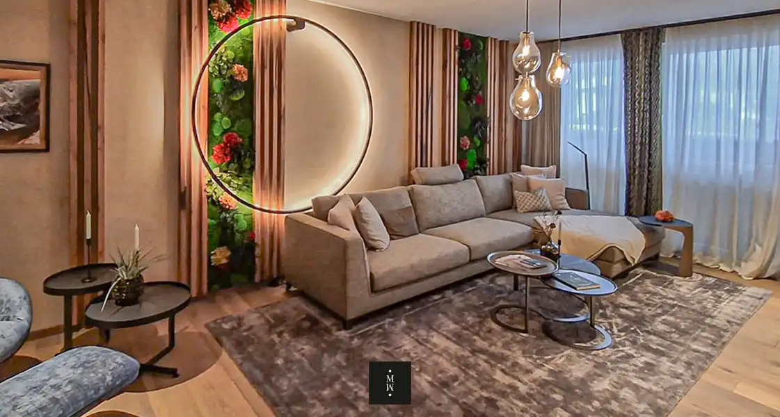 a living room with a couch and a round lamp