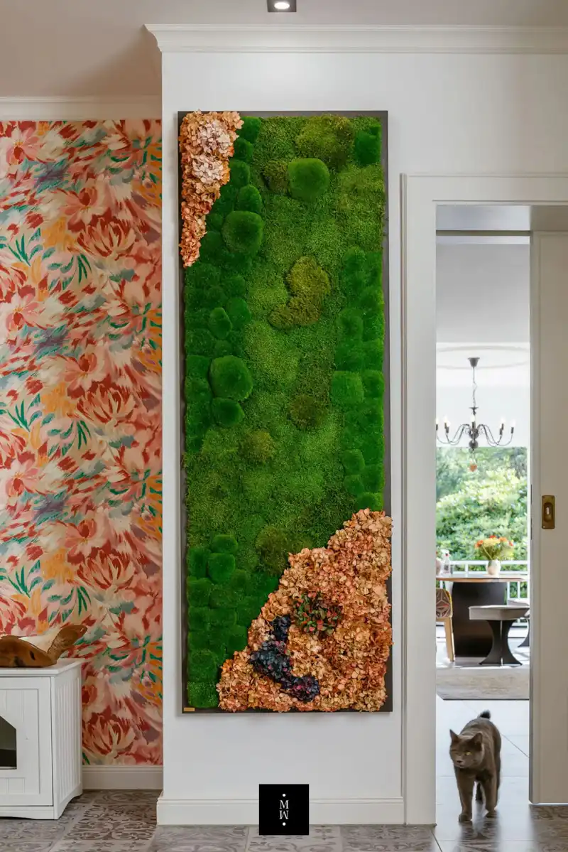 a wall with moss and flowers