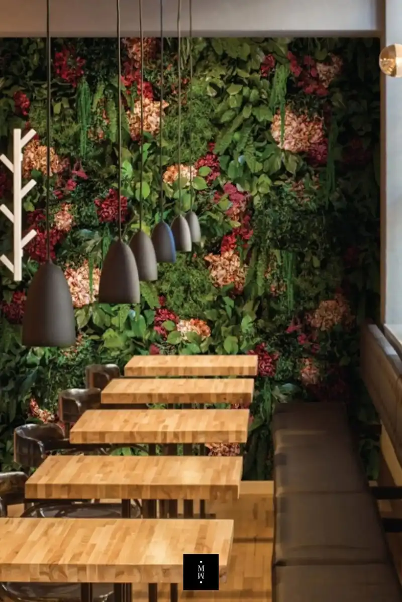 a table and chairs in a room with plants