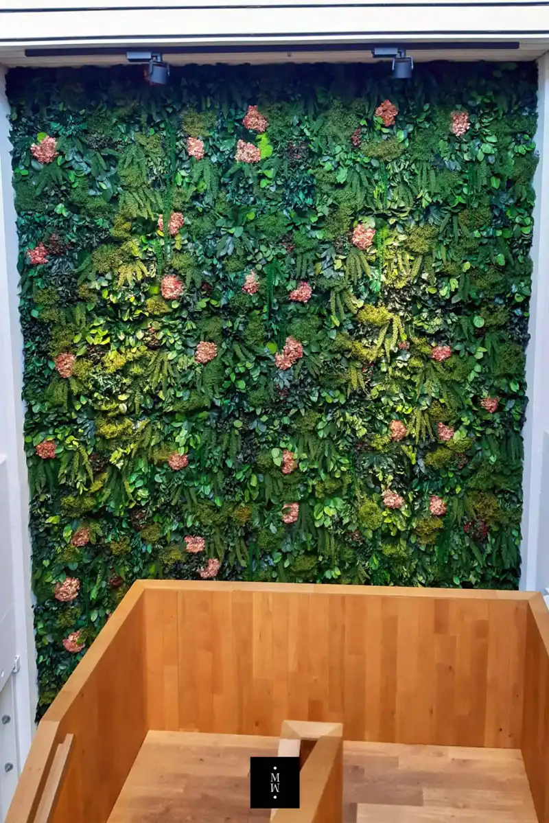 a green wall with flowers and a wood floor