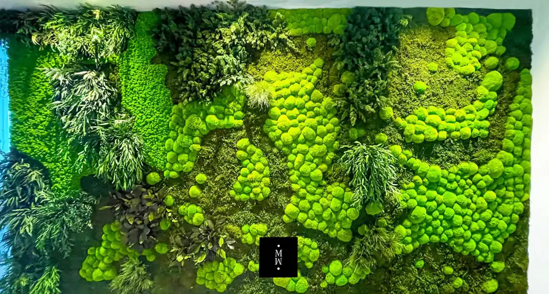 a green wall with plants and trees