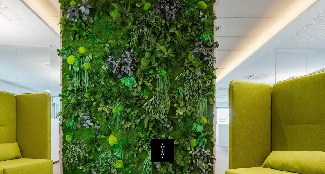 a green wall with plants on it