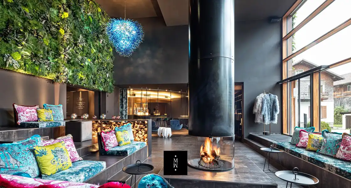 a room with a fireplace and a plant wall