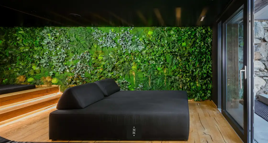 a black bed in a room with a green wall