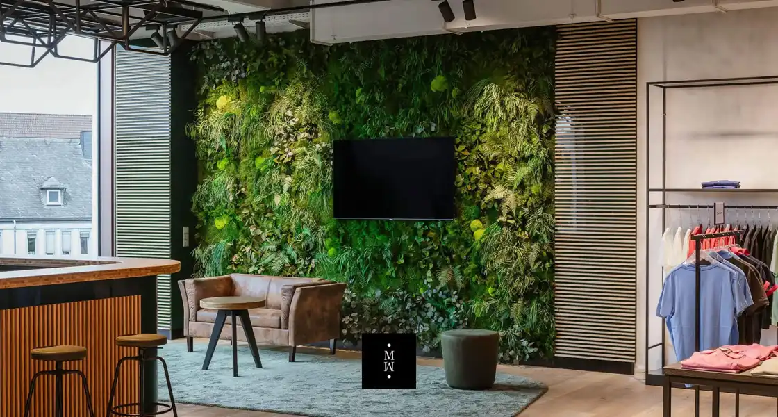 a room with a wall of plants