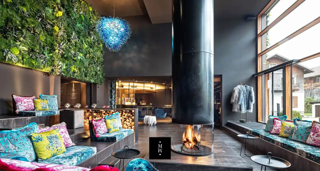 a room with a fireplace and a plant wall