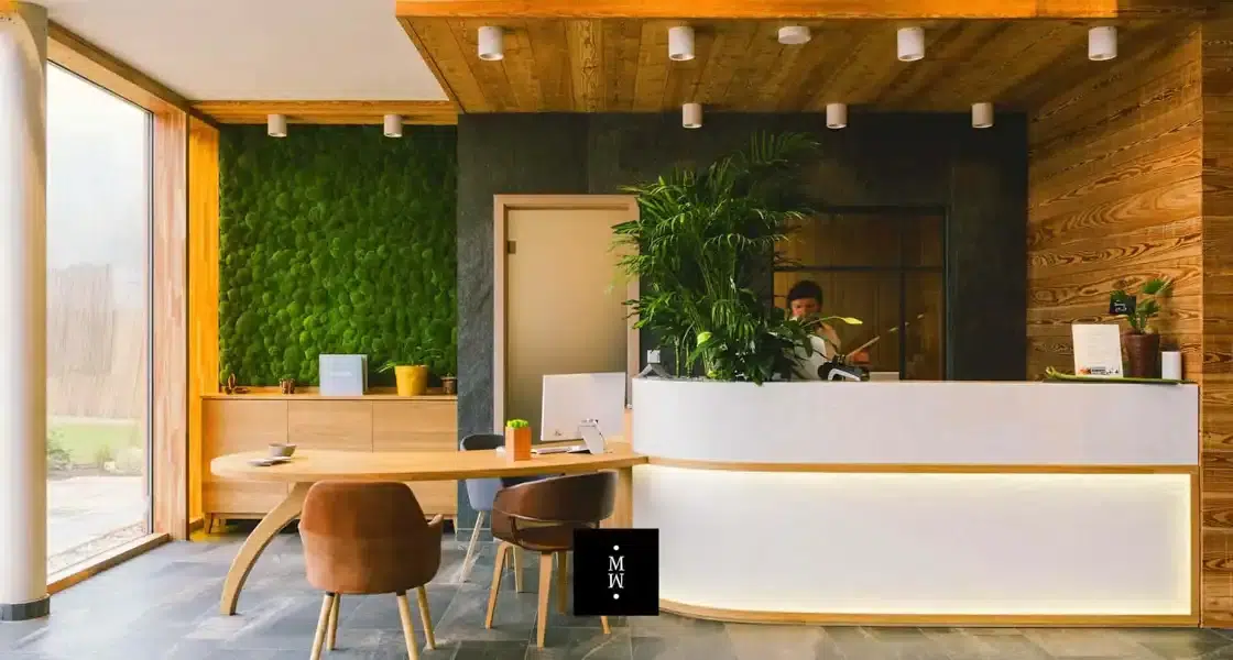 a man standing behind a reception desk