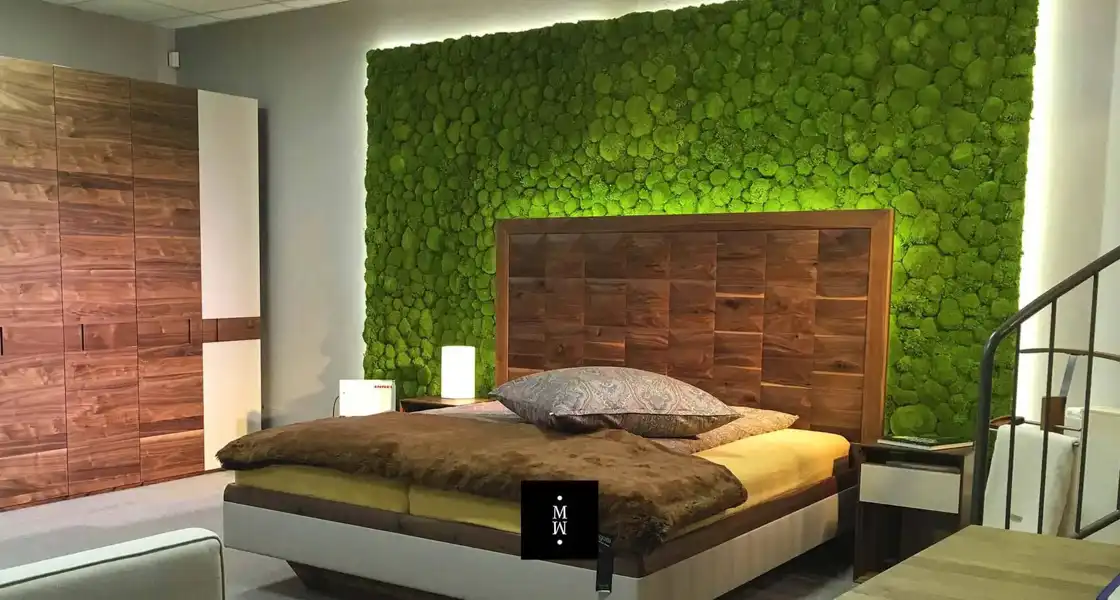 a bed with a green wall