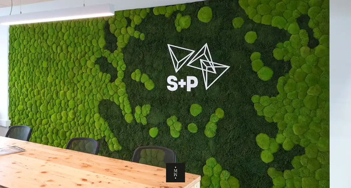 a green wall with white text and white letters on it