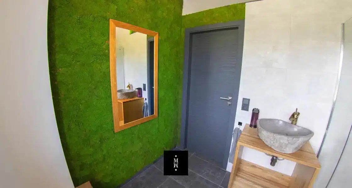 a mirror on a wall next to a sink