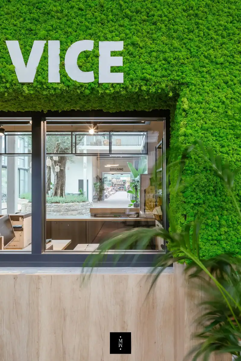 a building with a green wall and a sign