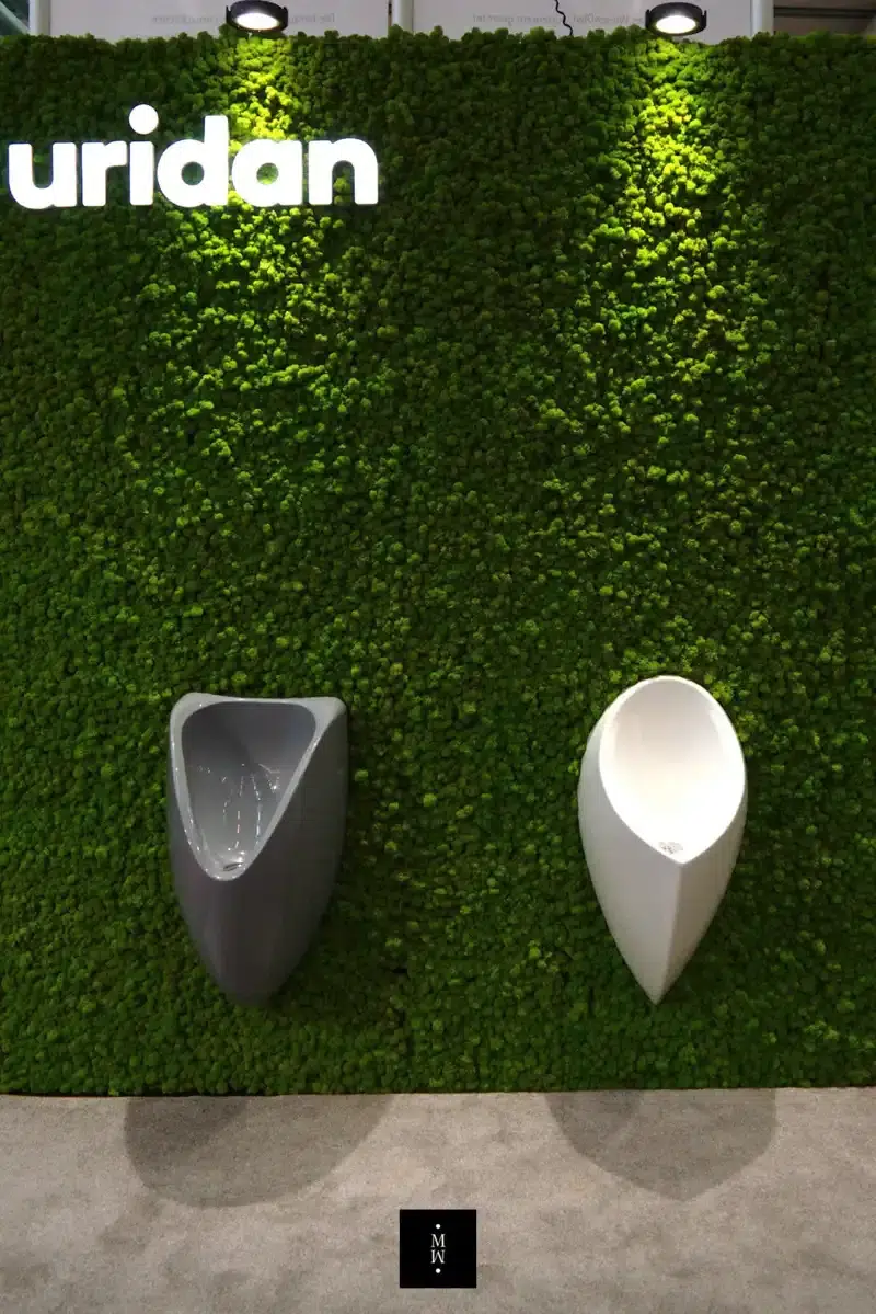 a urinals on a green wall