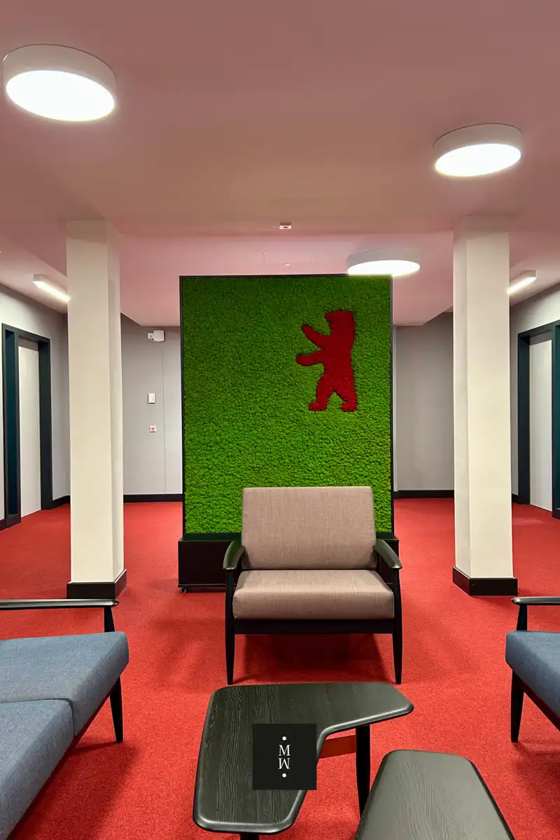a chair and a table in a room with a green wall