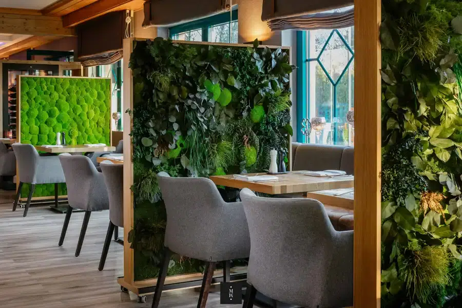 a room with a wall of plants