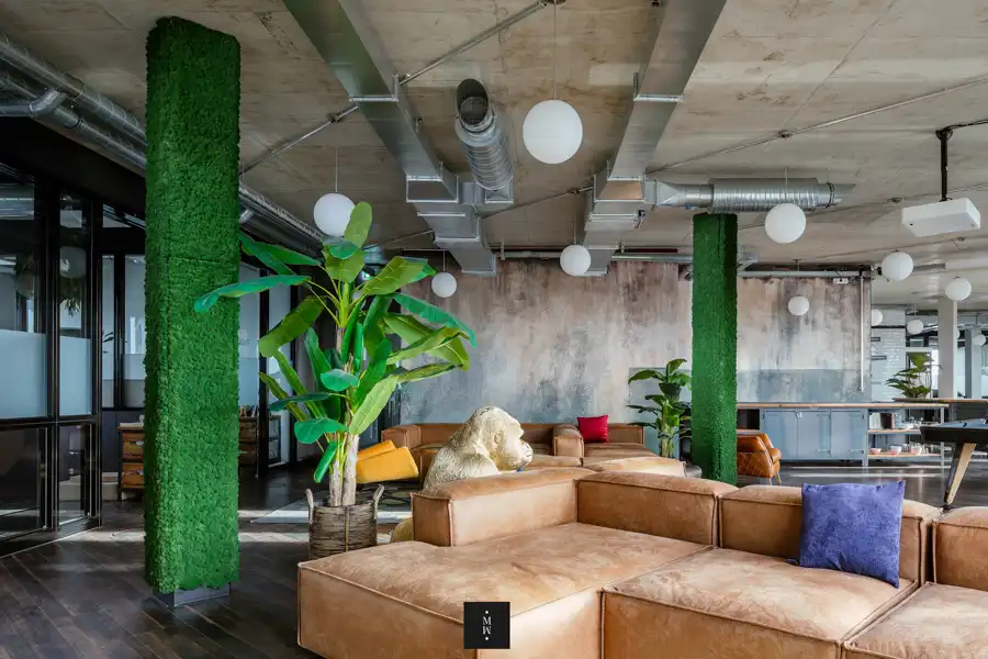 a room with a couch and a plant