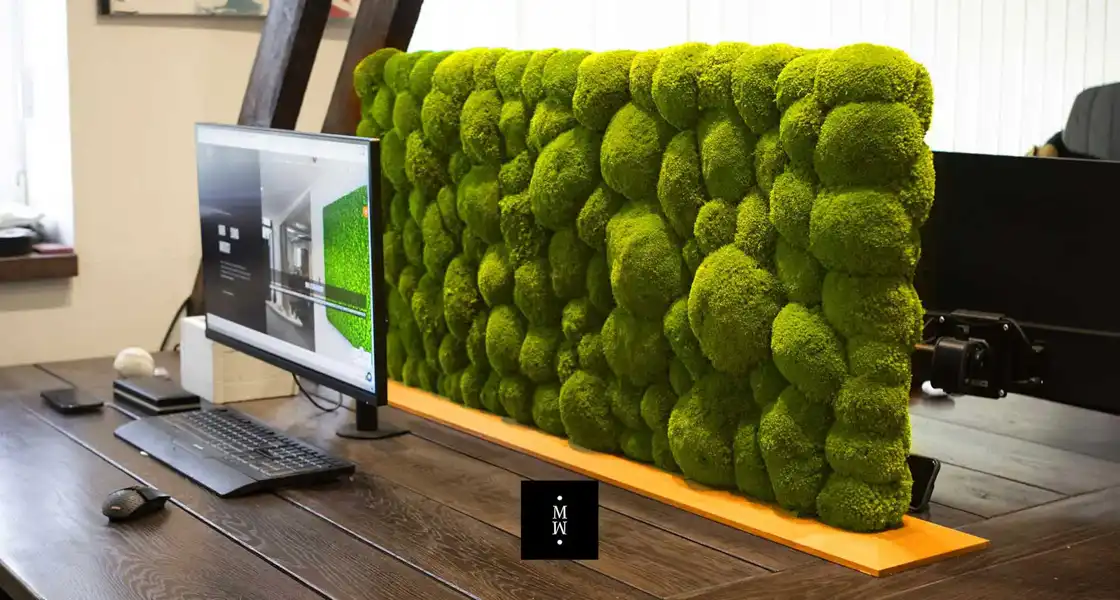 a green wall with a computer and a screen