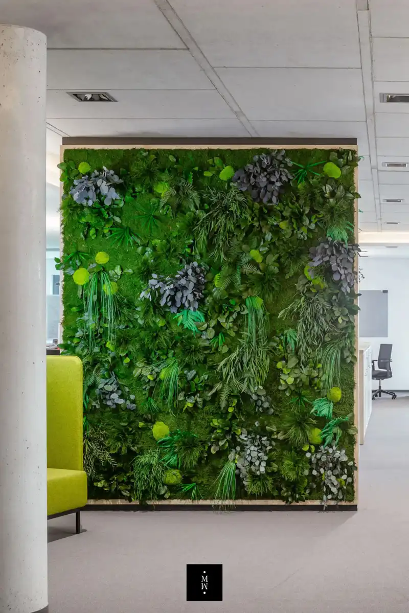 a green wall with plants on it