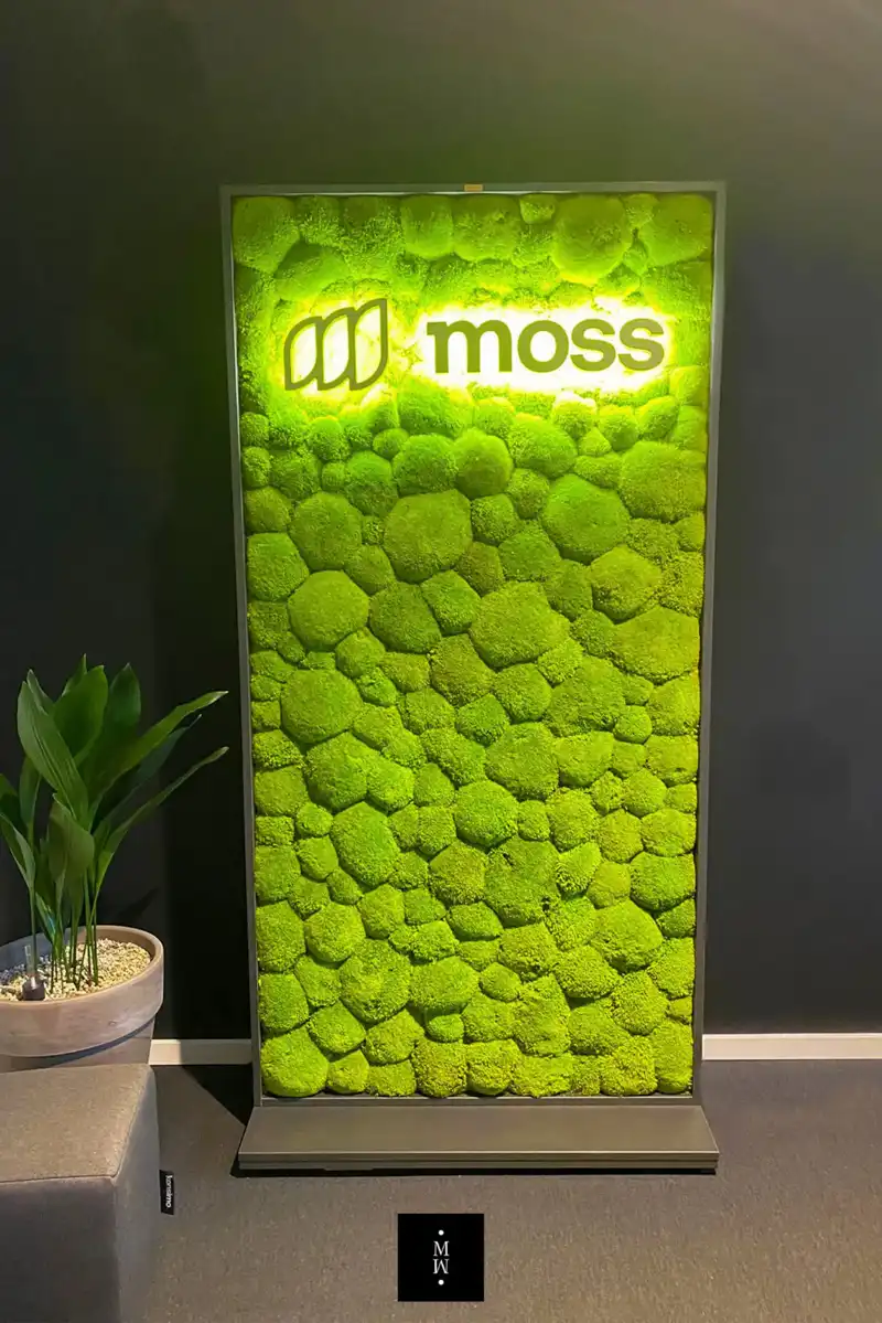 a green moss covered sign